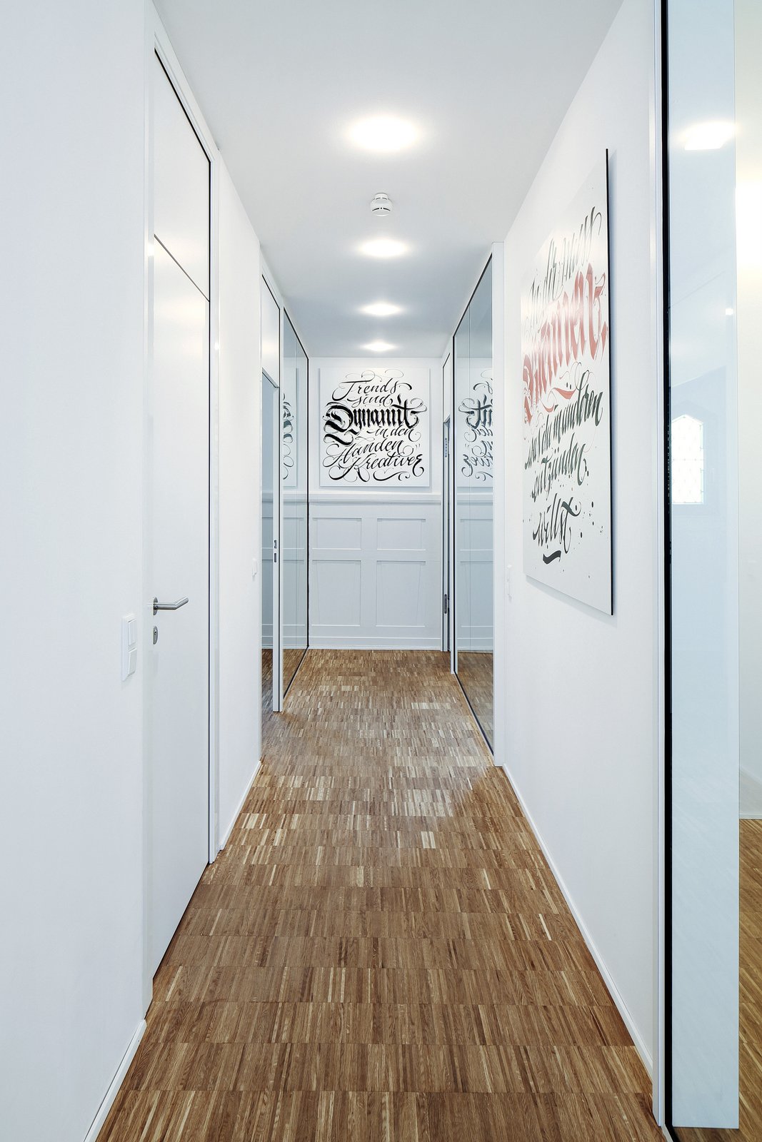 lorong kantor dengan latai parket dan dinding putih
